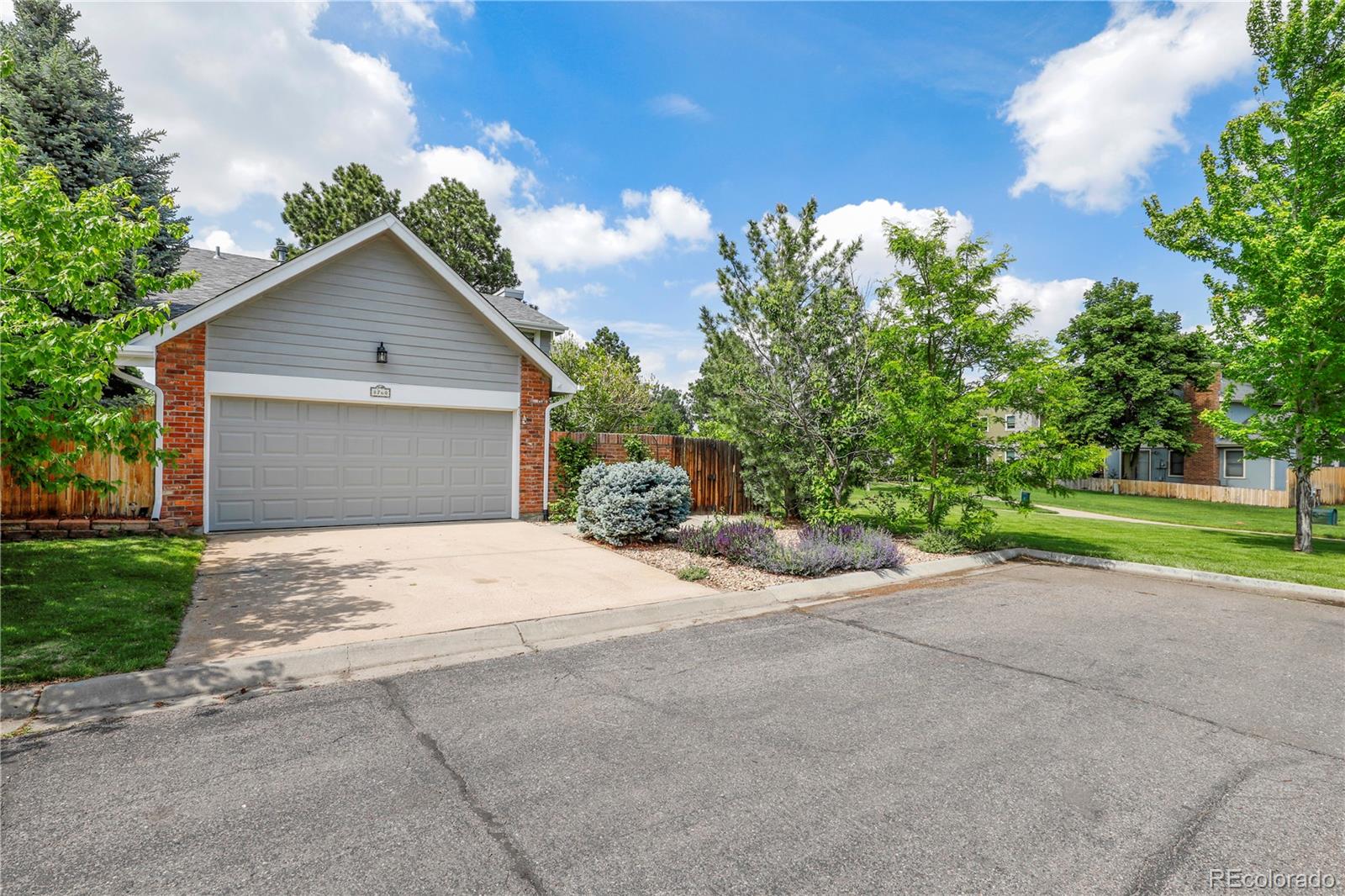 8760 Independence Way Arvada, CO 80005 - Photo 1 of 40 a front view of a house with a yard and a garage