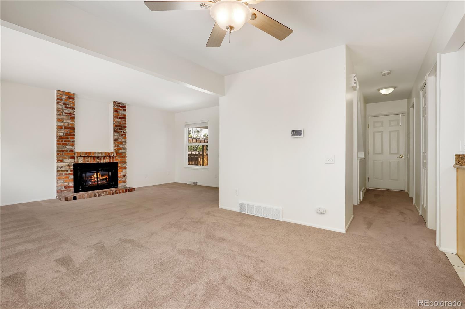 8760 Independence Way Arvada, CO 80005 - Photo 18 of 40 an empty room with windows and fireplace