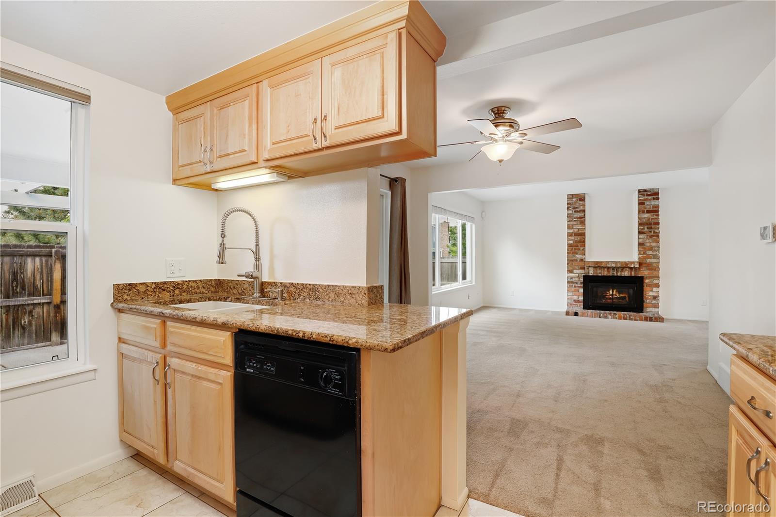 8760 Independence Way Arvada, CO 80005 - Photo 21 of 40 a view of a kitchen with a sink and dishwasher with white cabinets