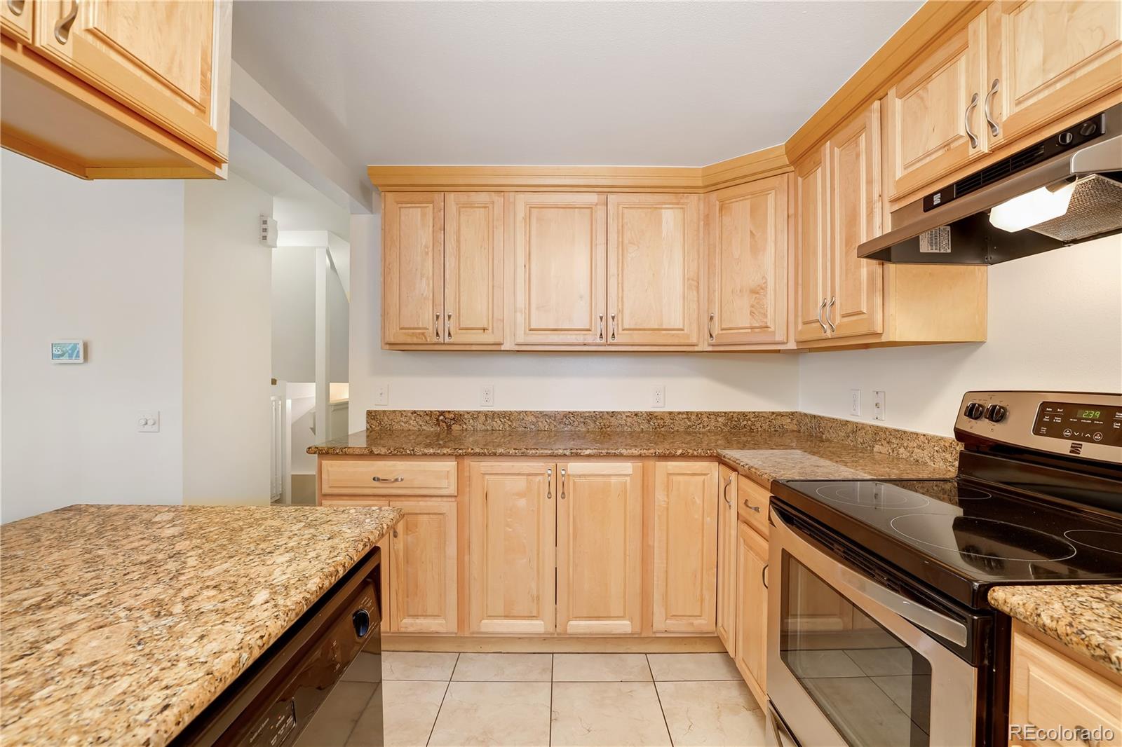 8760 Independence Way Arvada, CO 80005 - Photo 22 of 40 a kitchen with a stove and a sink
