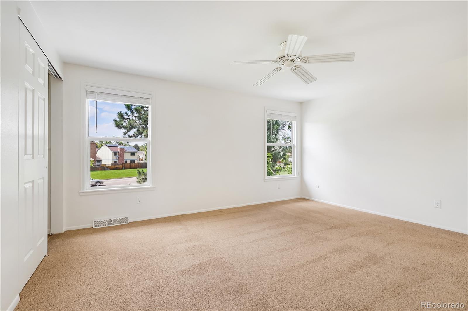 8760 Independence Way Arvada, CO 80005 - Photo 31 of 40 an empty room with windows and fan