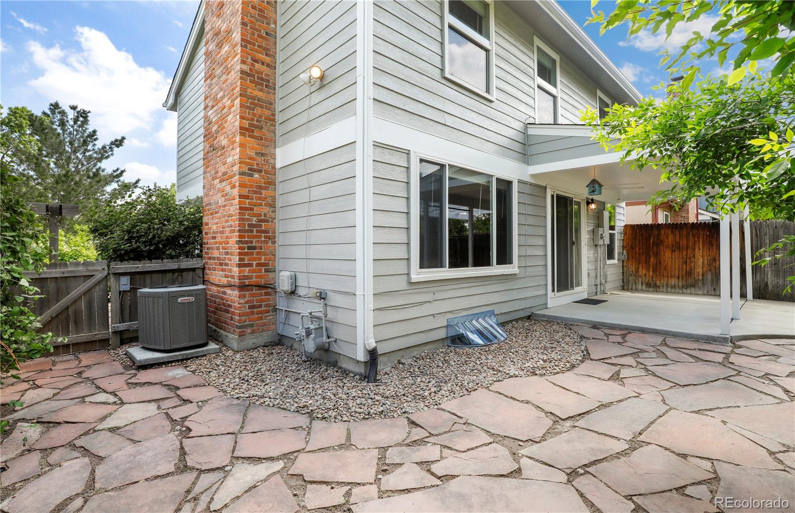 8760 Independence Way Arvada, CO 80005 - Photo 5 of 40 a front view of a house with plants