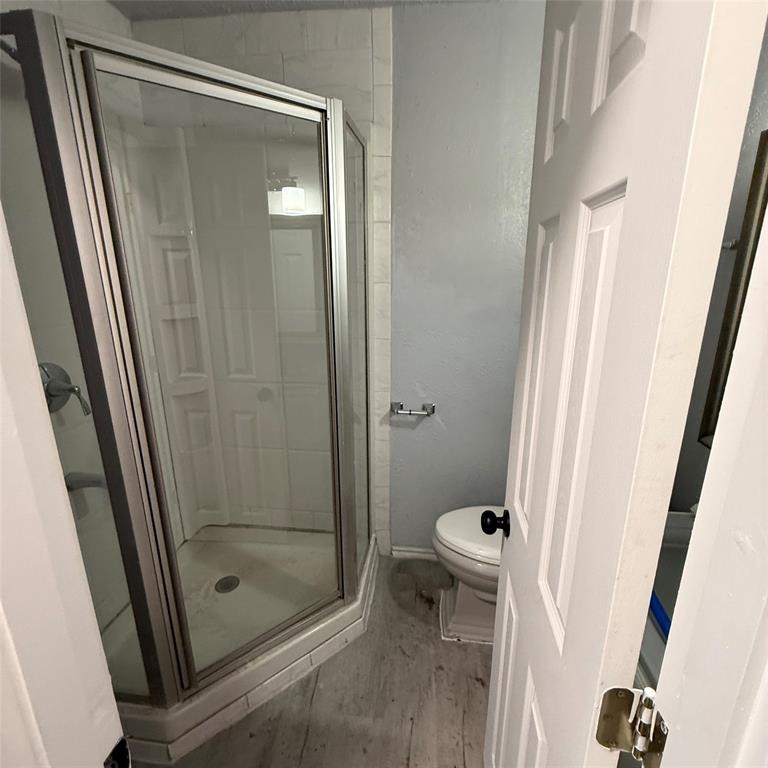 1713 Willow Street Grand Prairie, TX 75050 - Photo 1 of 4 a bathroom with a shower and toilet