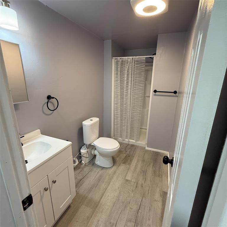1713 Willow Street Grand Prairie, TX 75050 - Photo 3 of 4 a bathroom with a sink a toilet and shower