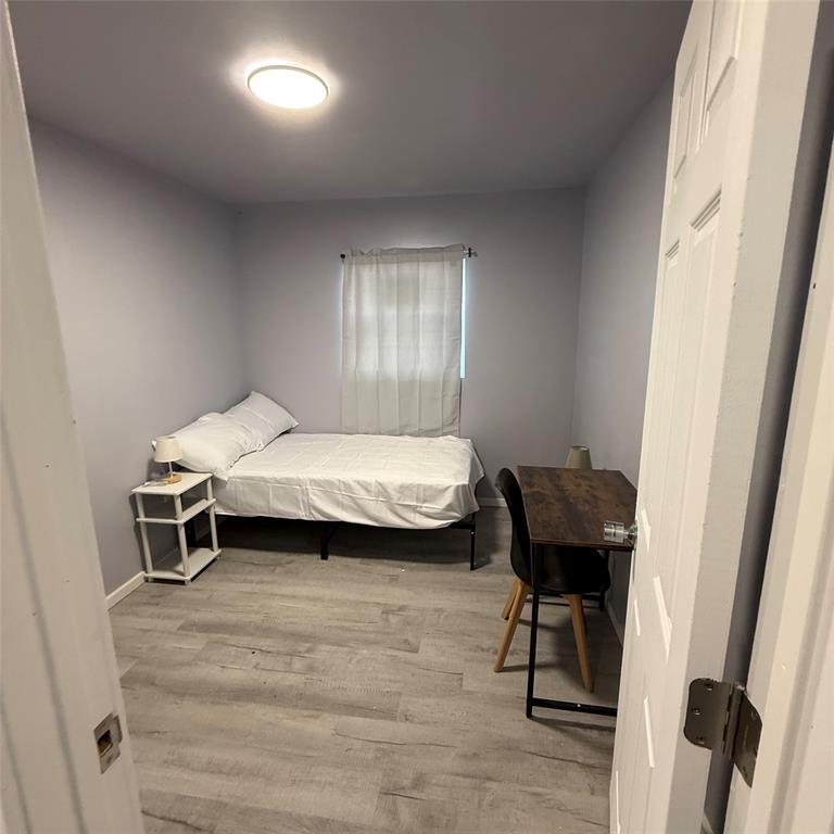 1713 Willow Street Grand Prairie, TX 75050 - Photo 4 of 4 a bedroom with a bed and a table