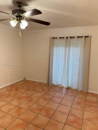 a view of a room with a chandelier fan and fire place
