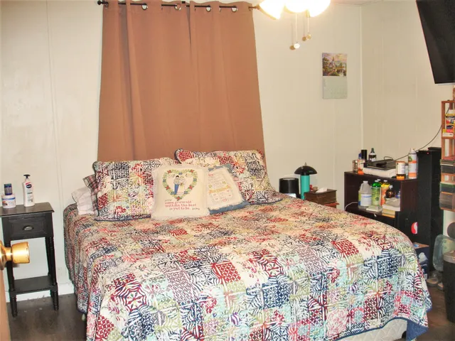 a bedroom with a bed and curtain