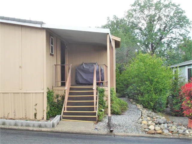 a view of a house with a small yard and plants