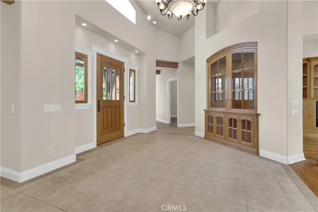 a view of an empty room with entrance and door