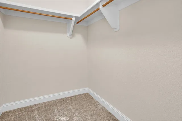 a view of a storage and utility room with washer and dryer