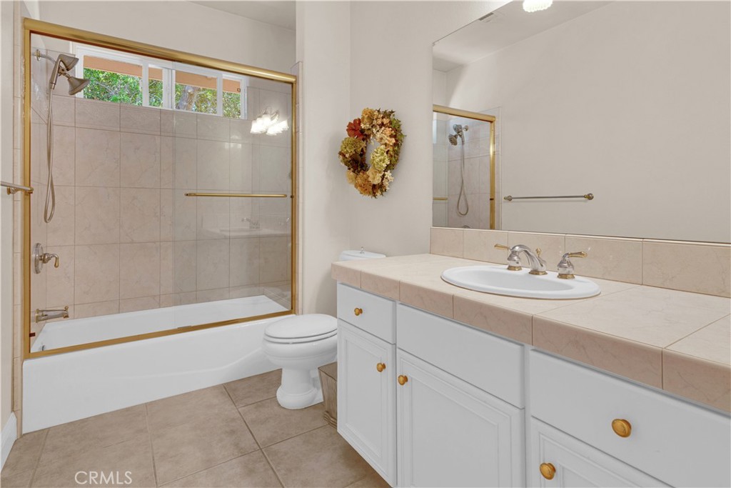 117 Frontier Way Templeton, CA 93465 - Photo 39 of 60 a bathroom with a granite countertop sink a toilet and shower