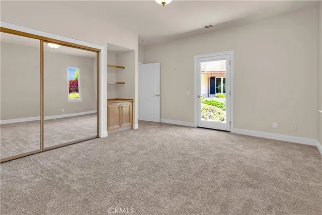 a view of a street with potted plants and large trees