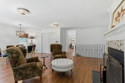 a living room with furniture a window and a fireplace