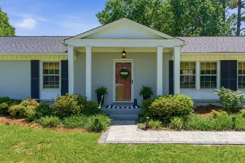 a front view of a house with garden