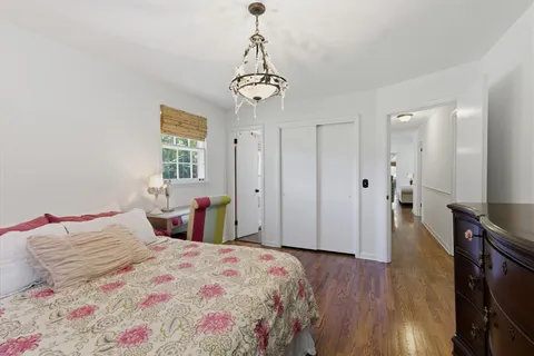 a bedroom with a bed and a chandelier