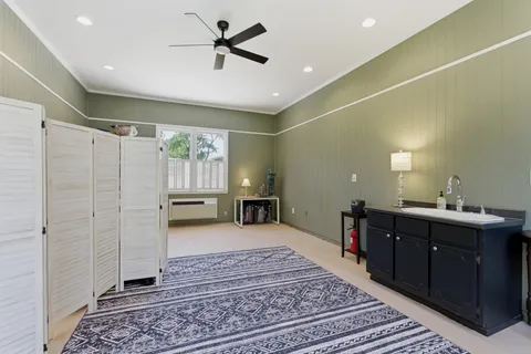 a spacious bedroom with a large bed and a chandelier