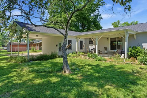a front view of house with a garden