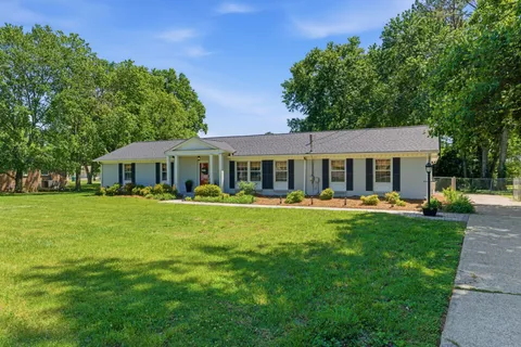 a front view of a house with swimming pool having outdoor seating