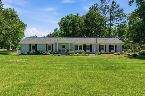 a front view of house with yard and green space