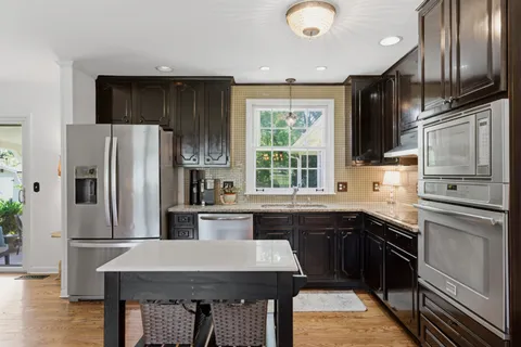 a kitchen with stainless steel appliances a refrigerator sink and stove
