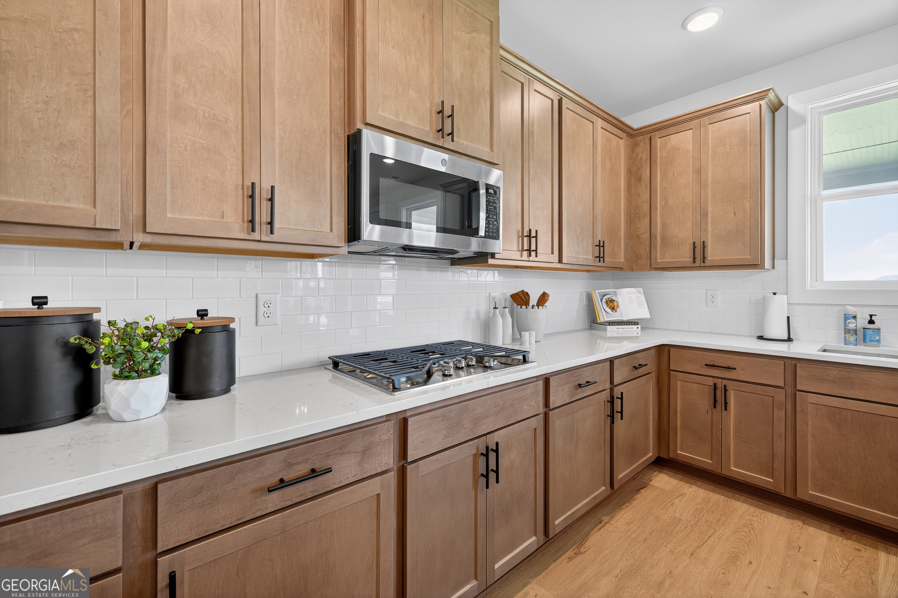 112 Patillo Manor, Unit 3 Stockbridge, GA 30281 - Photo 15 of 59 a kitchen with cabinets and white appliances