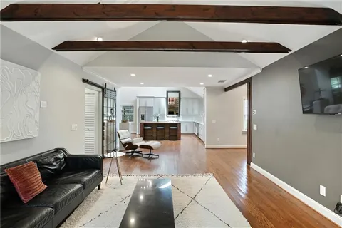 a large kitchen with granite countertop a lot of counter space and wooden floor