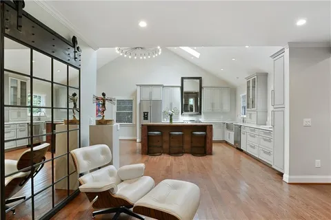 a kitchen with refrigerator cabinets and wooden floor