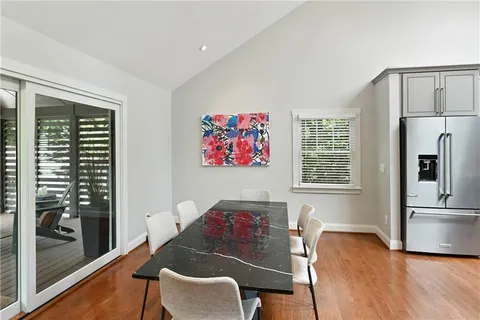 a view of hallway with wooden floor and a window