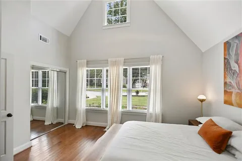 a view of a patio with couches table and chairs and potted plants