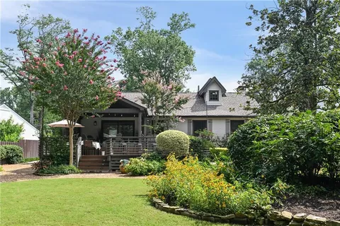 a sign that is sitting on a bath in a yard