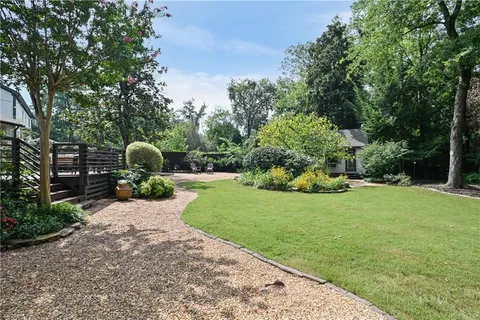 a front view of a house with a yard and potted plants