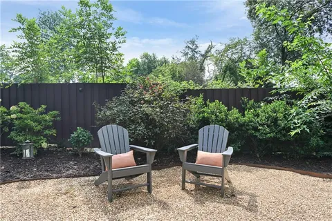 a living room with furniture and a ceiling fan