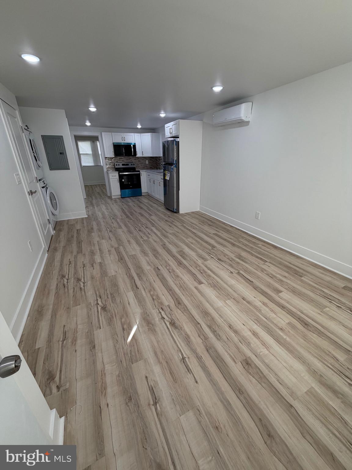 a view of a room with wooden floor and furniture