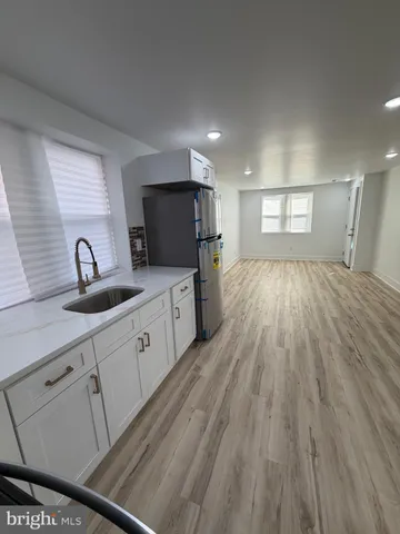 a large kitchen with granite countertop a sink dishwasher stove and cabinets