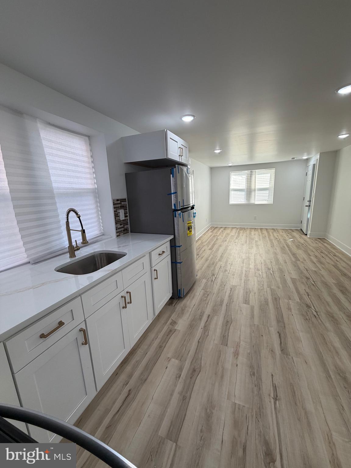 7810 Limekiln Pike, Unit 1 Philadelphia, PA 19150 - Photo 11 of 16 a large kitchen with granite countertop a sink dishwasher stove and cabinets