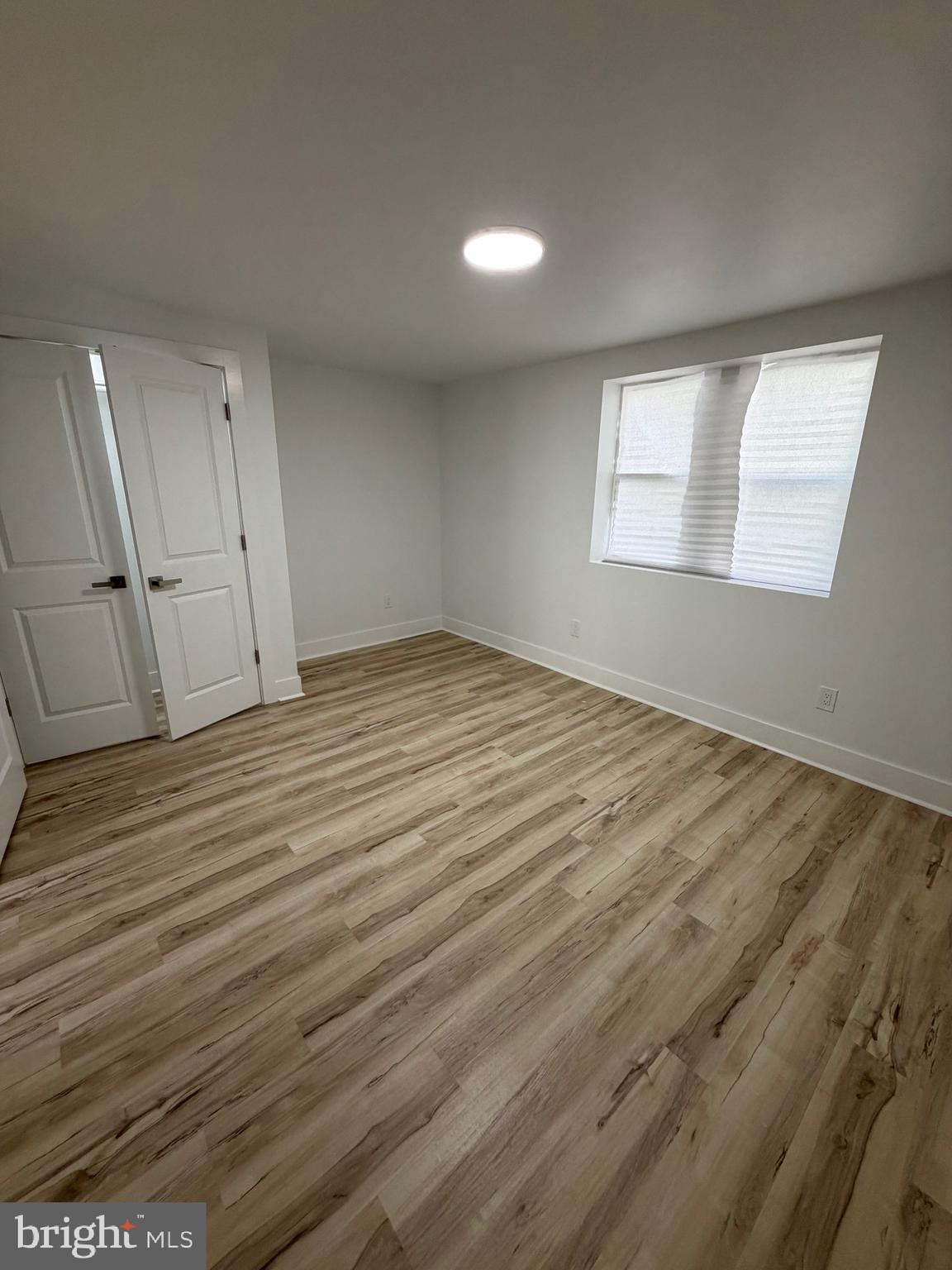 7810 Limekiln Pike, Unit 1 Philadelphia, PA 19150 - Photo 13 of 16 an empty room with wooden floor and windows