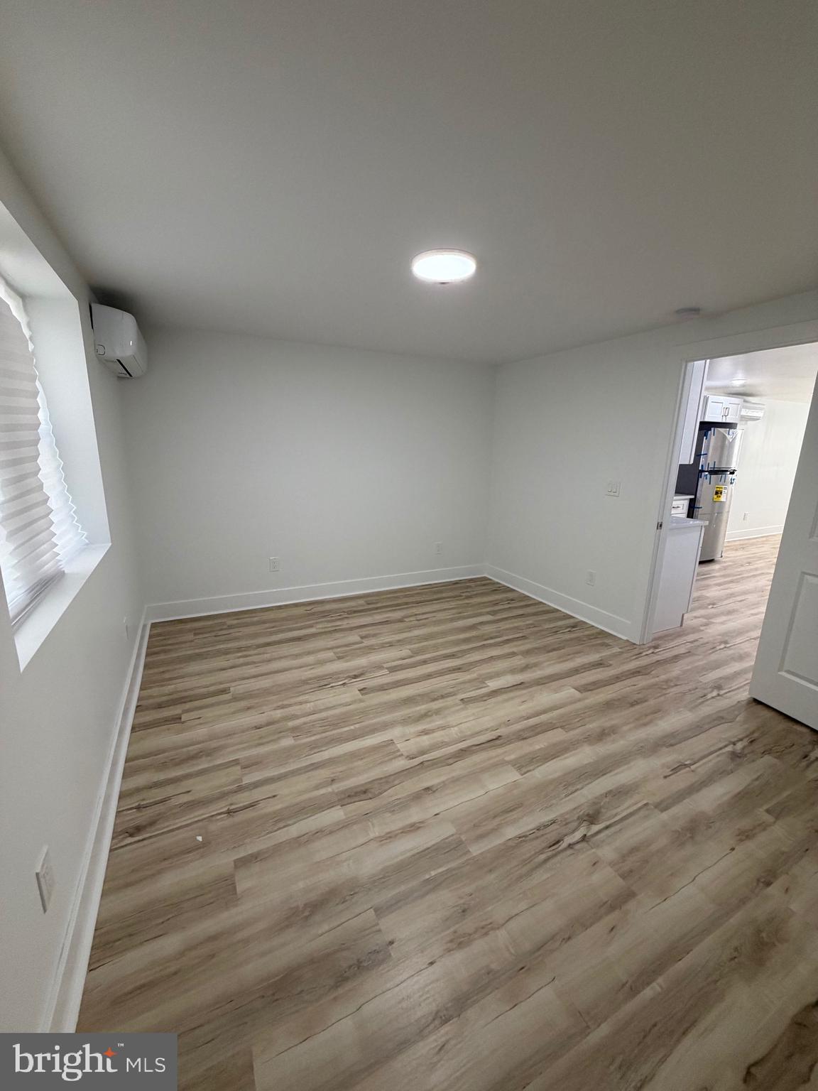 7810 Limekiln Pike, Unit 1 Philadelphia, PA 19150 - Photo 15 of 16 an empty room with wooden floor and windows