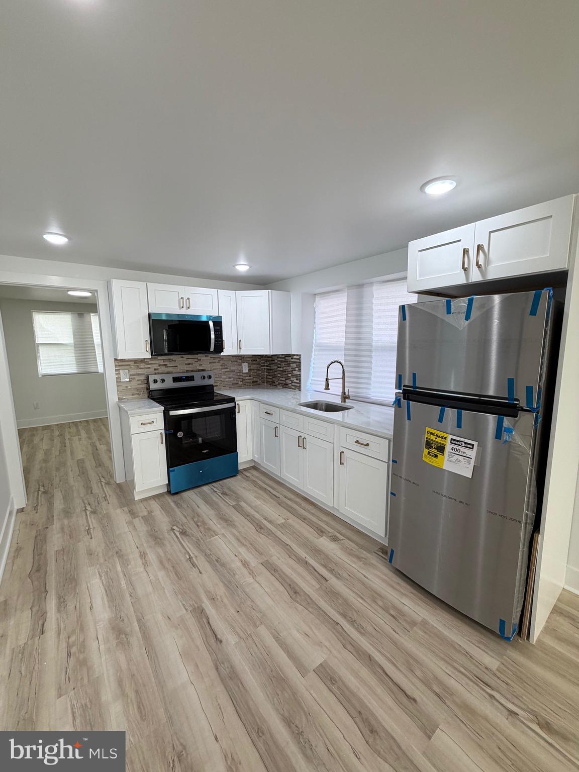 7810 Limekiln Pike, Unit 1 Philadelphia, PA 19150 - Photo 5 of 16 a kitchen with stainless steel appliances a refrigerator sink and microwave