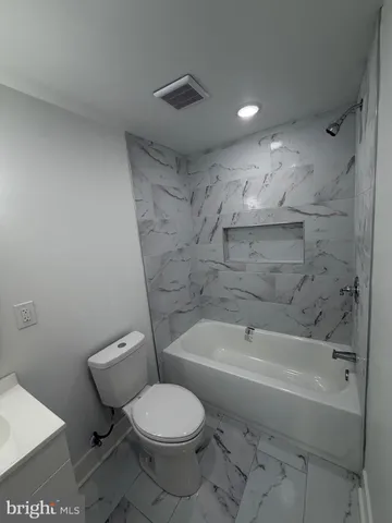 a bathroom with a toilet and a bathtub