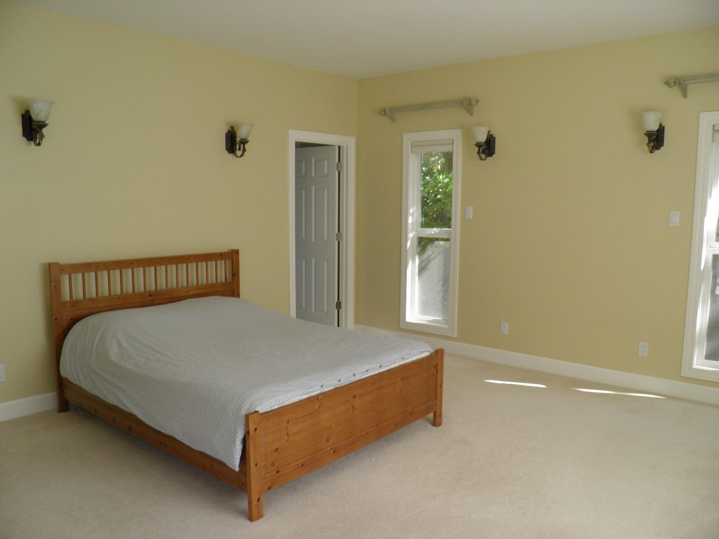 836 Springer Road Los Altos, CA 94024 - Photo 4 of 9 a bed sitting in a bedroom next to a bathroom