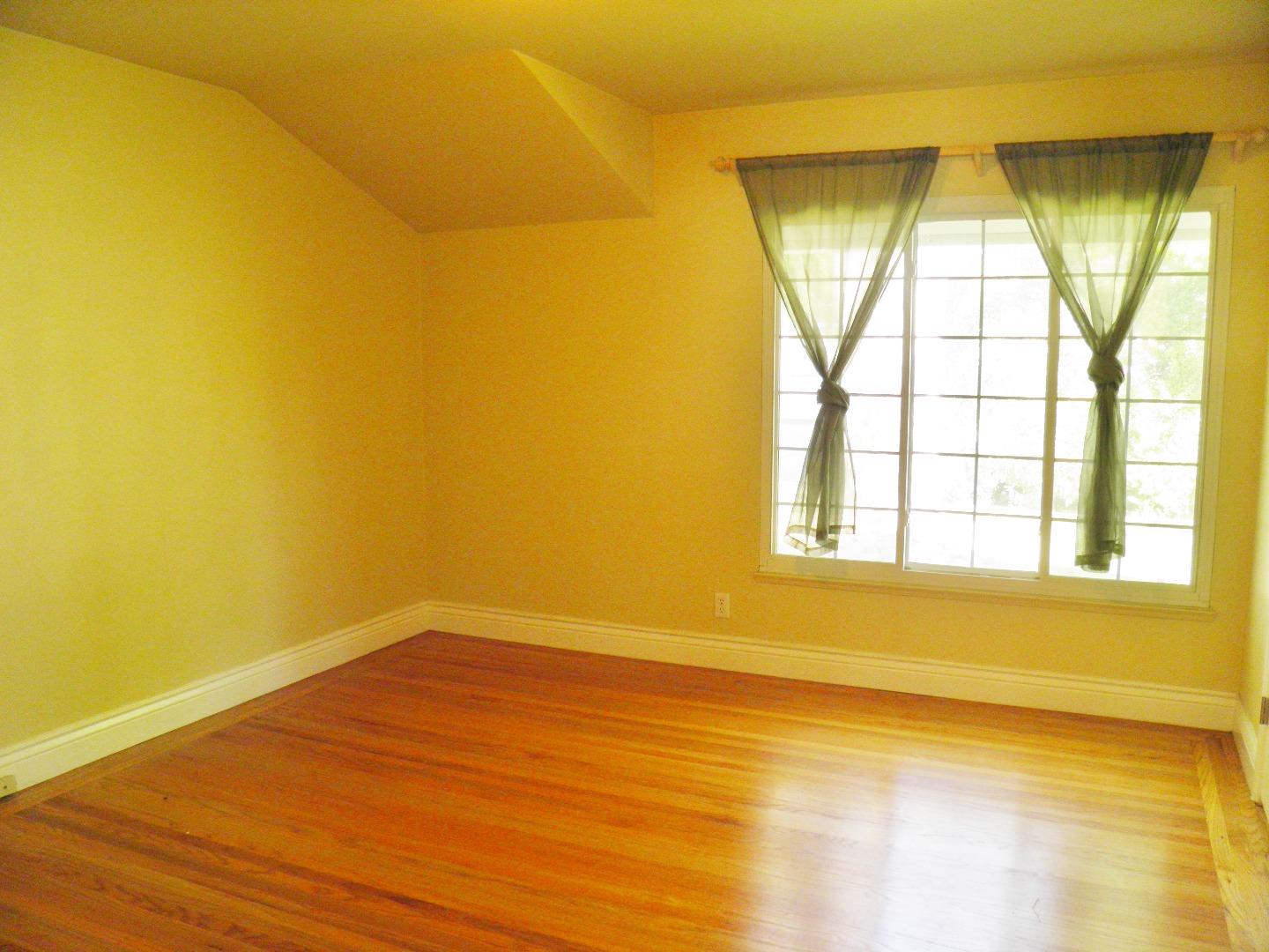 836 Springer Road Los Altos, CA 94024 - Photo 7 of 9 a view of an empty room with wooden floor and a window