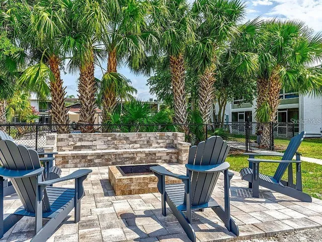 a view of house with swimming pool and sitting area