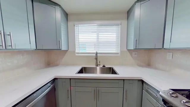a kitchen with a sink and cabinets