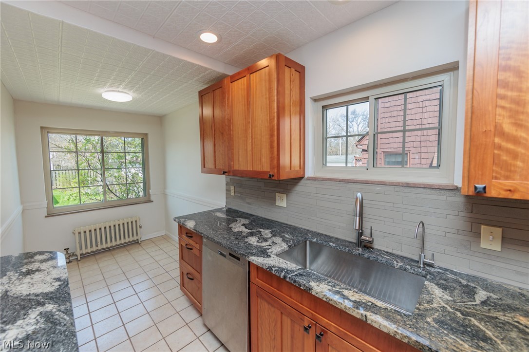 2472 Eaton Road Cleveland, OH 44118 - Photo 18 of 50 Kitchen with sink, radiator, plenty of natural light, and stainless steel dishwasher