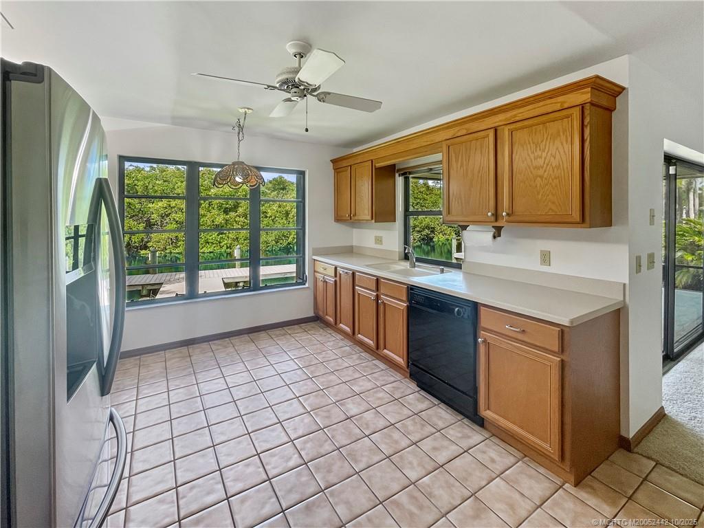 735 Southwest Salerno Road Stuart, FL 34997 - Photo 12 of 27 a kitchen with stainless steel appliances granite countertop a stove a sink and a refrigerator