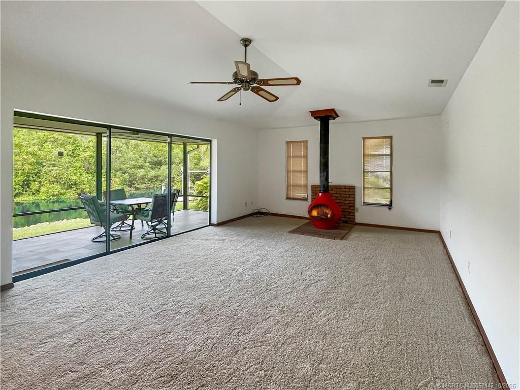 735 Southwest Salerno Road Stuart, FL 34997 - Photo 14 of 27 a living room with furniture and a large window