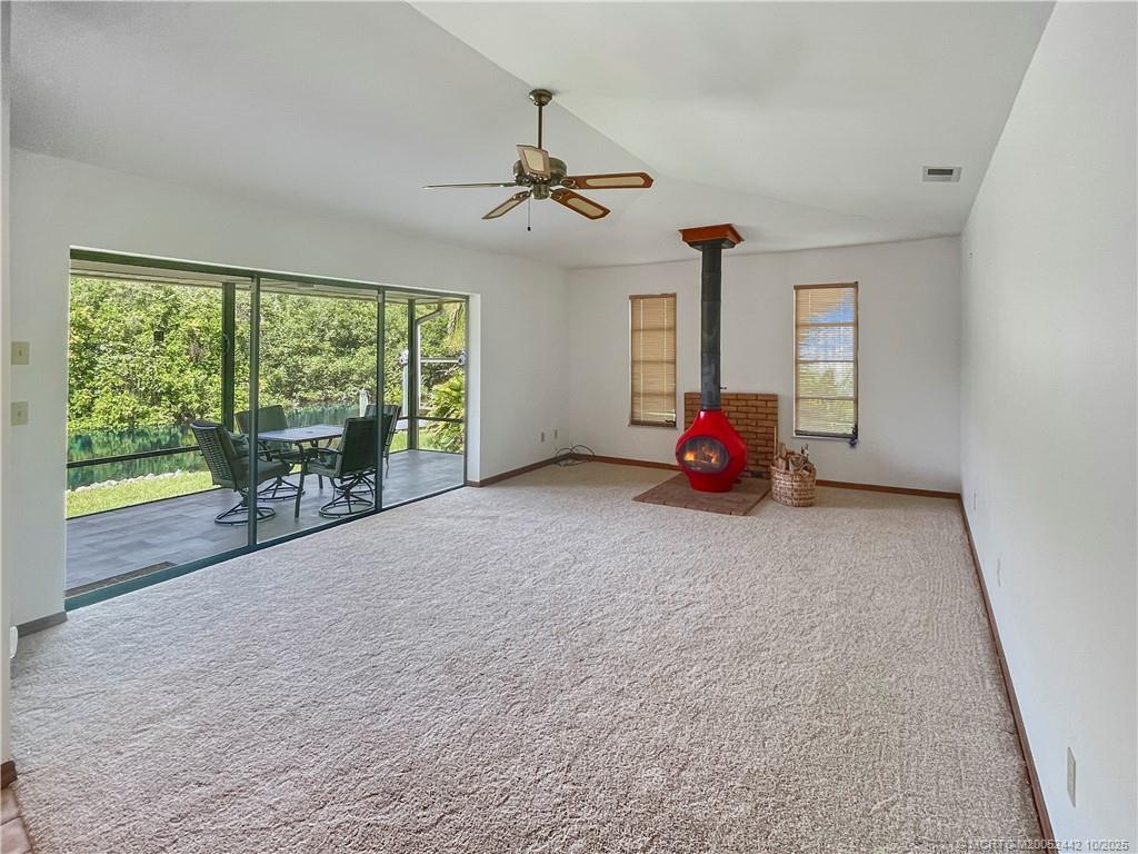 735 Southwest Salerno Road Stuart, FL 34997 - Photo 15 of 27 a living room with furniture and a large window