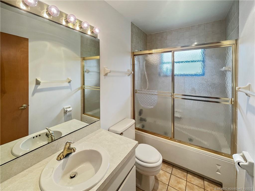 735 Southwest Salerno Road Stuart, FL 34997 - Photo 21 of 27 a bathroom with a sink and a mirror