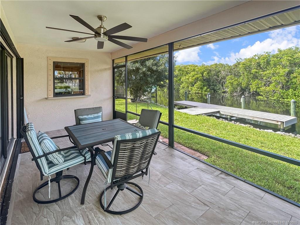 735 Southwest Salerno Road Stuart, FL 34997 - Photo 5 of 27 a dining room with furniture and a large window