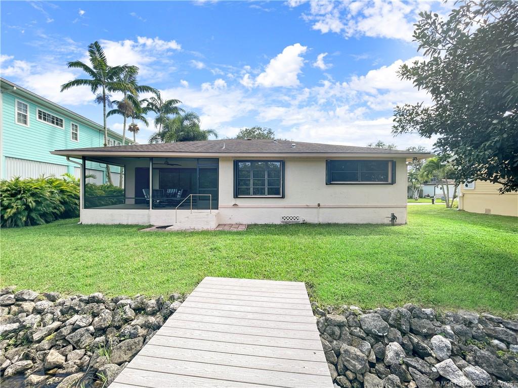 735 Southwest Salerno Road Stuart, FL 34997 - Photo 8 of 27 a front view of a house with a garden and yard